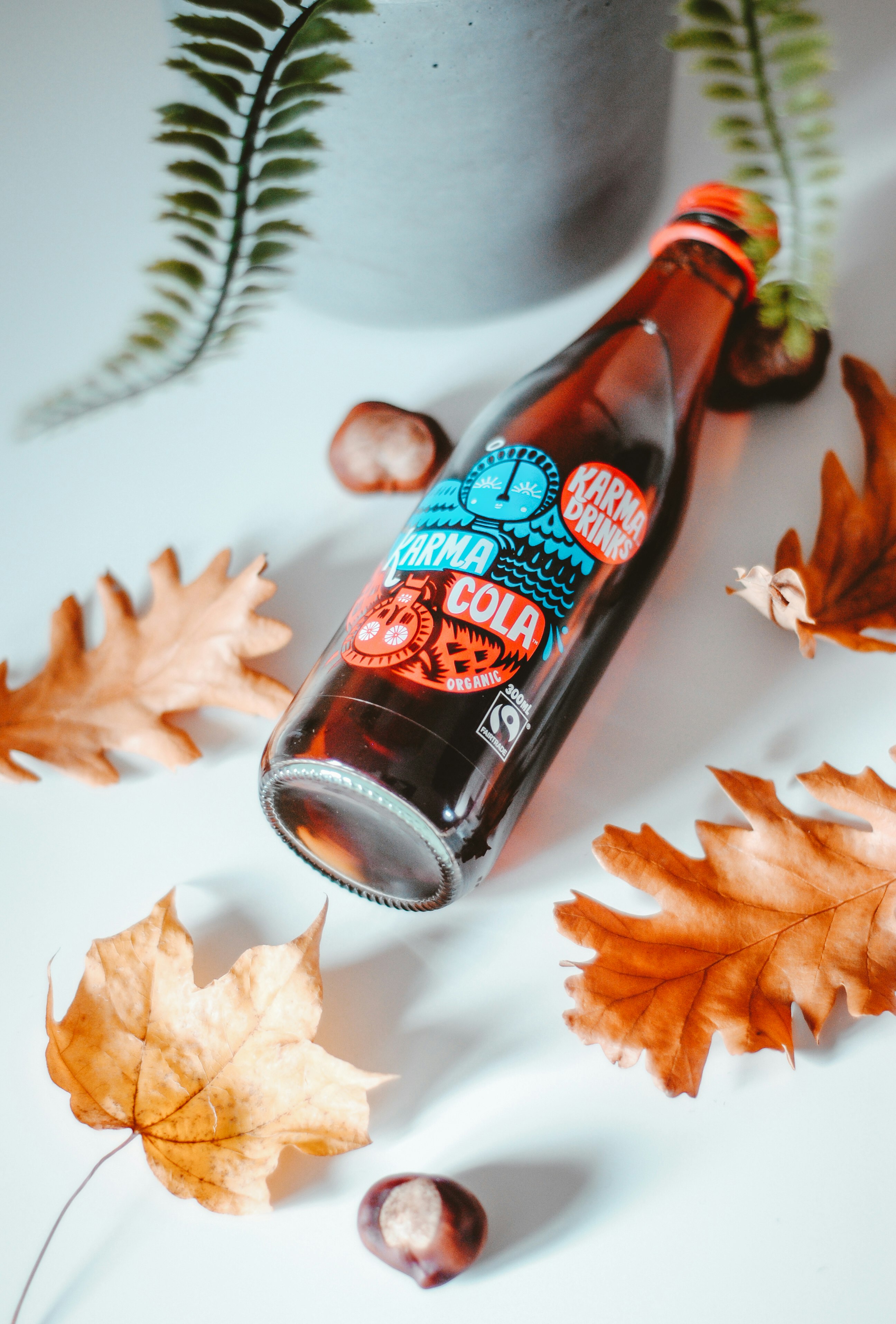 brown glass bottle on white textile